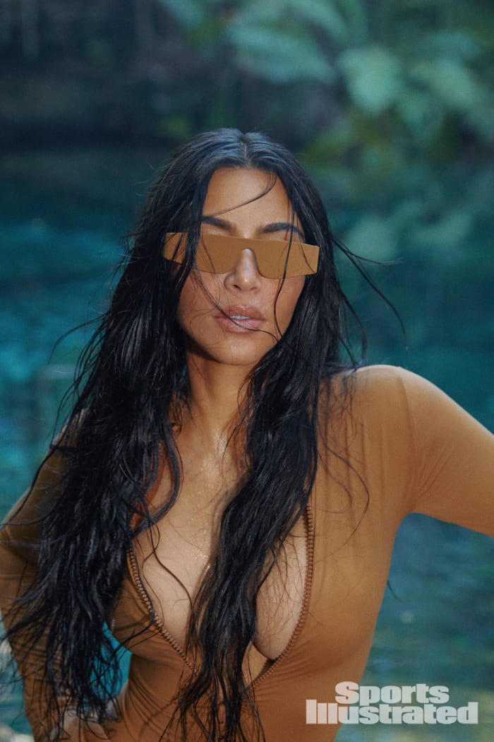 Kim Kardashian was photographed by Greg Swales in the Dominican Republic. Swimsuit by SKIMS. Sunglasses by Hall of Frames.